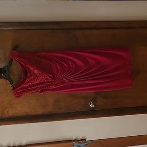 Red dress with sequined lace details and pleated layers.